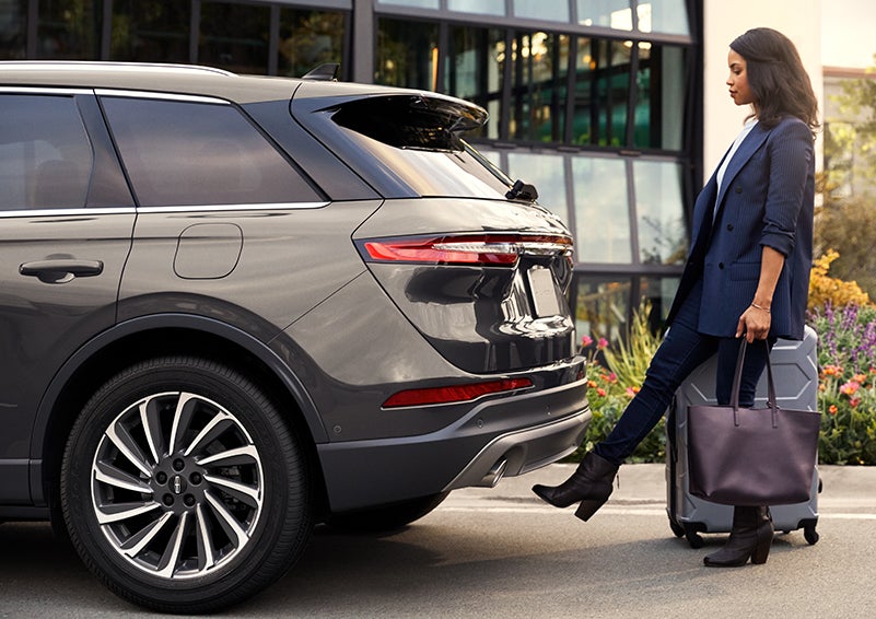 A woman with her hands full uses her foot to activate the hands-free liftgate. | North Park Lincoln at Dominion in San Antonio TX