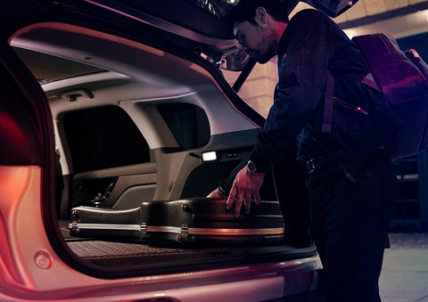 A man is shown loading cargo into the rear of a 2023 Lincoln Corsair® SUV with the second-row seats folded flat. | North Park Lincoln at Dominion in San Antonio TX